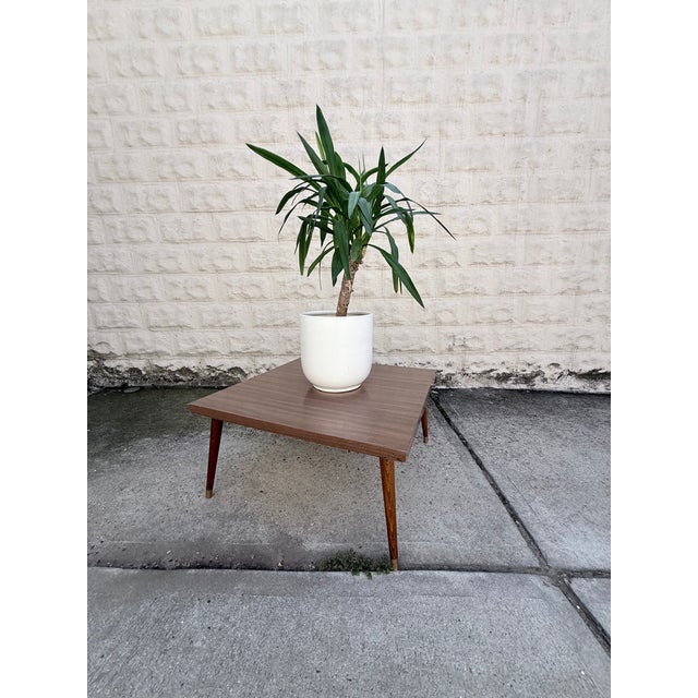 Mid-Century Single-Tiered Square Coffee Table with Glossy Laminate Top, Wood Legs and Brass Caps. Unknown Maker.