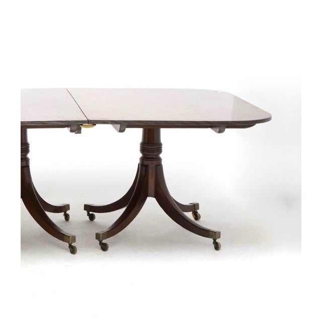 Early 19th century Regency mahogany triple-pedestal dining table, a refined example of English Regency craftsmanship,...