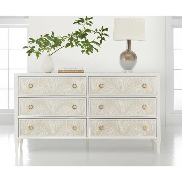 Features intricate palm frond patterns applied to the drawer fronts. The sophisticated design pairs crisp white painted...