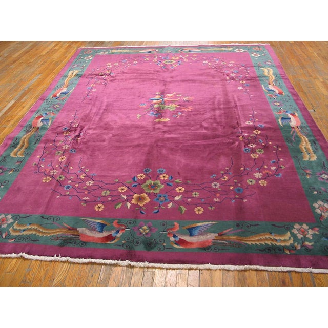 On each of the four border sides are facing pairs of feng-hung (phoenix) birds with long wavy tail feathers, set around a...