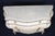 A wonderfully decorative pair of Italian Rococo Louis XV-style bombé commodes, beautifully finished in a soft crème-...