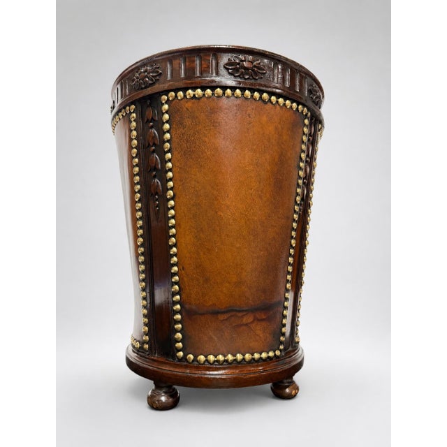 A good quality English leather, mahogany and brass-mounted waste paper basket, dating to the early 20th century, of...