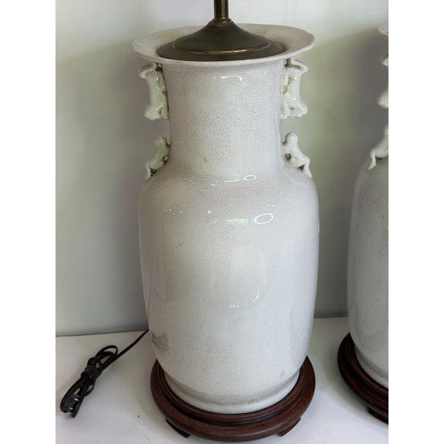 English Vintage Large Chinese Blanc De Chine Crackle Glazed Porcelain Foo Dog Handle Table Lamps on Hardwood Bases a Pair For Sale - Image 3 of 11