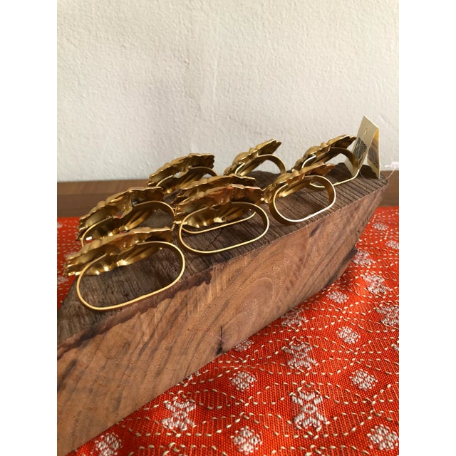 Wonderful set of matte gold stamped metal napkin rings from GUMPS San Francisco. Round wreath of vegetables in very...