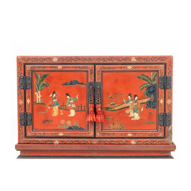 This elegant antique Chinese cabinet exemplifies the refined artistry of the late Qing Dynasty, featuring a richly...