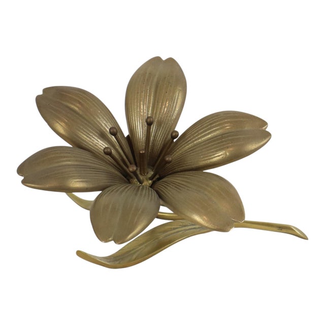 A beautiful, large mid-century brass lily flower sculpture or figurine—a vintage Hollywood Regency-style ashtray shaped...