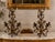 An extraordinary pair of circa 1940s Italian decorative candelabra crafted in dark patinated metal with remnants of a warm...