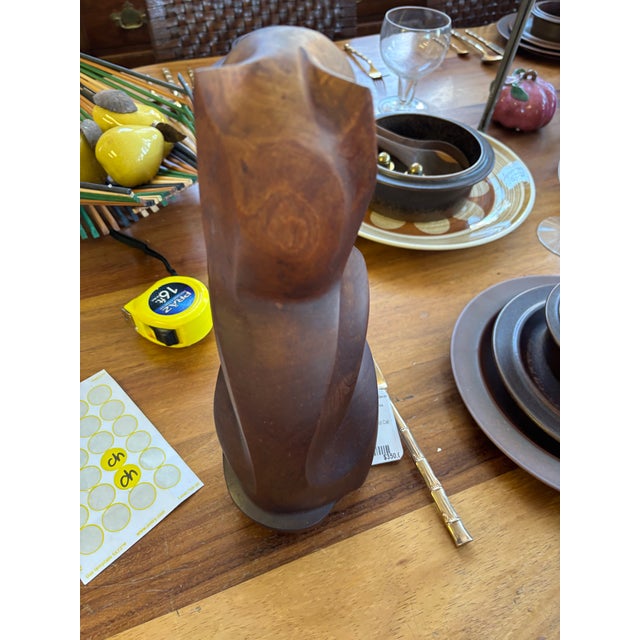 Stunning vintage hand-carved wooden cat figurine featuring smooth, faceted contours and a rich dark wood grain.