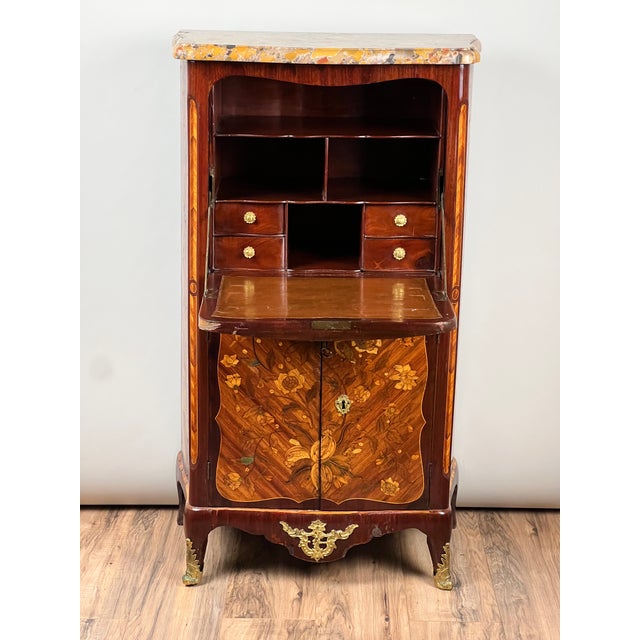 This lovely diminutive secrétaire à abattant is done in the Louis XV taste, dating to the 19th century, and richly...