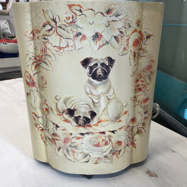 Whimsical vintage metal lamp with a cream background and a pair of charming pugs gracing the front. They are encircled...