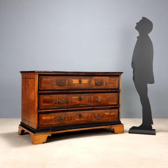 Three-drawer chest of drawers from the early 18th century, from the Lake Garda area. Constructed of split-front fir, it is...