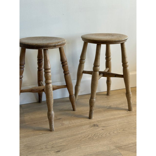 A pair of antique English stools with simple, well-balanced proportions and softly worn surfaces that speak to years of...