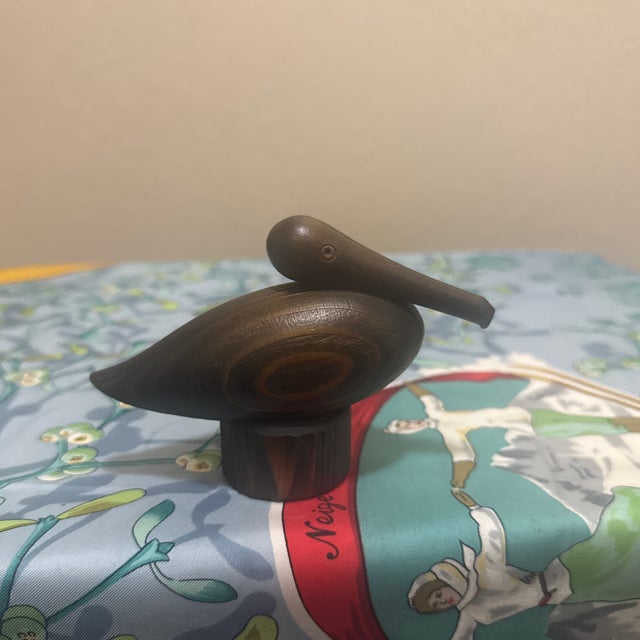 An elegant and organic Mid-Century Modern stylized pelican sculpture, masterfully hand-carved from a rich, highly grained...