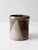 This vintage studio pottery crock features a sweeping taupe and brown glaze with a dynamic, fluid design. The handmade...