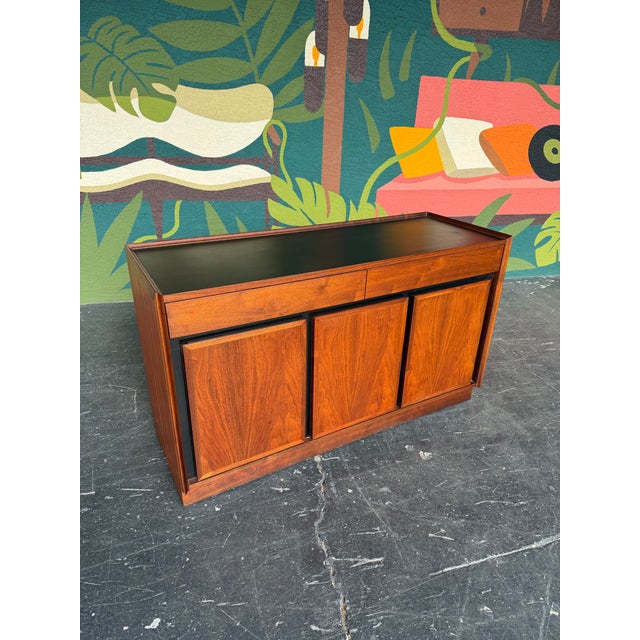 Mid Century Modern Buffet Credenza by Dillingham from the Esprit Line. Oil rubbed walnut case with black trim and black...