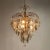 Offered here is a very pretty Hollywood regency style chandelier with smoked glass panes and crystal glass pendants. The...