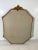 An Ornate octagon shape mirror with etchings. The frame is carved with gesso and gild finish.