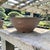 Large Japanese-style bonsai pot executed in unglazed brown stoneware with molded dragon relief decoration. The round basin...