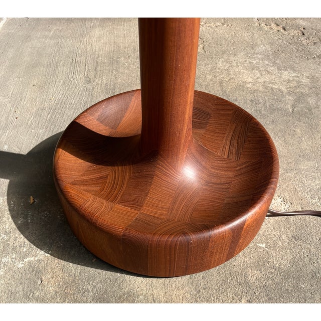 Floor lamp made of solid teak with an unusual bowl-shaped base, Denmark 1960s. It has two lighting modes. Very good...