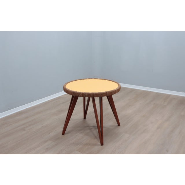 An elegant and original mid-century italian design round side table by augusto romano, 1940s. A well-executed table that...