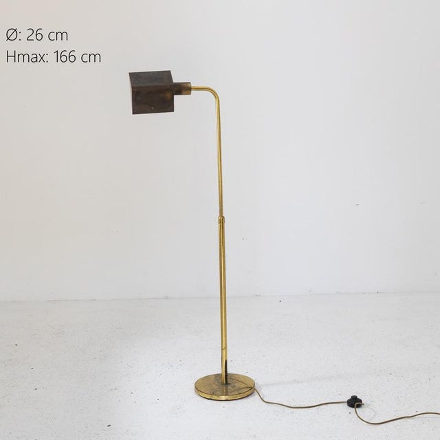 Description Floor lamp with circular base and slim brass structure. The stem is adjustable in height and ends with a...