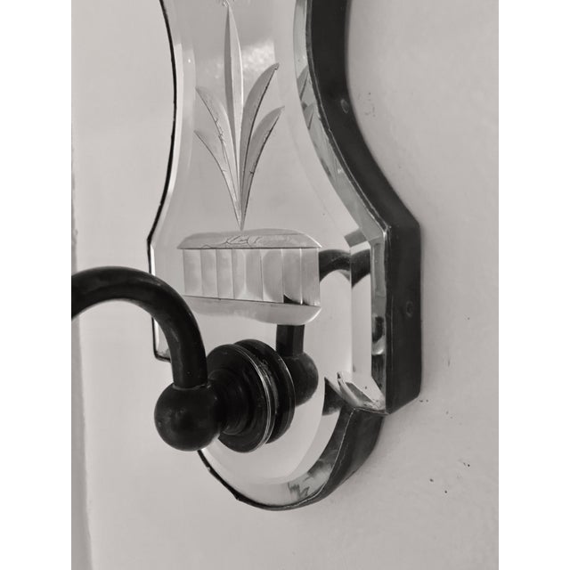 This handsome pair of beveled and wheel cut mirrored back sconces have patinated bronze arms. They are of 18th Century...