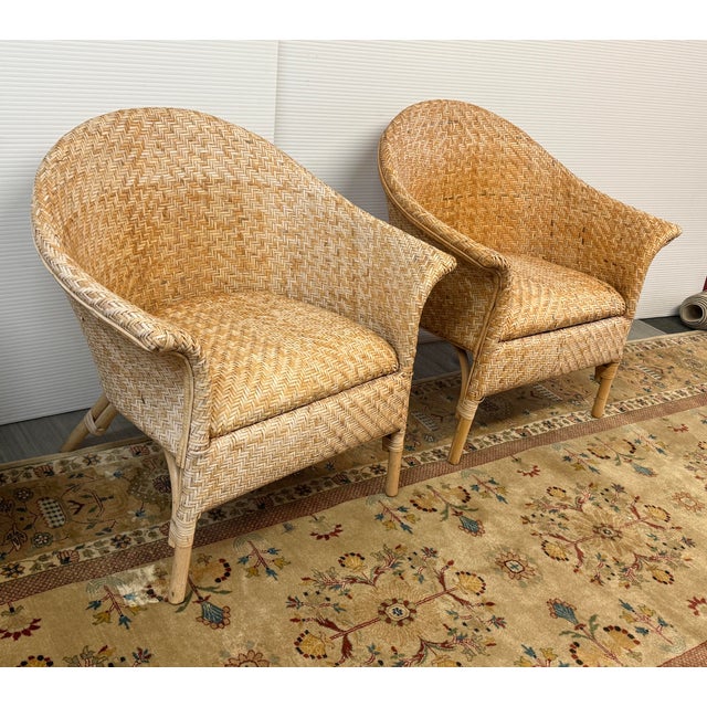 Design Plus Gallery presents a Pair of Woven Rattan Tub Chairs from the Mid 20th Century. The vintage set have a...