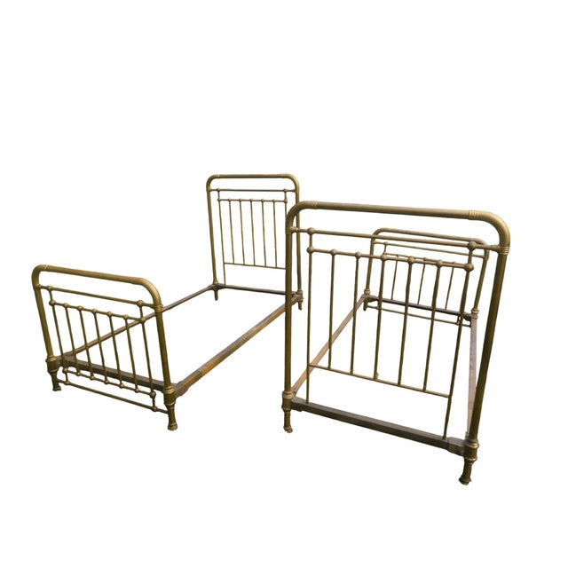 An exceptional matched pair of antique tubular brass twin beds by the renowned American maker Whitcomb Metallic Bedstead...