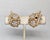 Circa 1960s goldtone round clear rhinestones forming two flowers inside a u shape clip earrings. Please note that based on...