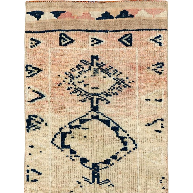 This mid-20th-century Turkish Anatolian runner presents a spare, highly graphic composition on a warm ivory and pale beige...