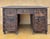 Solid and richly carved antique Spanish desk made of solid oak, dating from the early 20th century (circa 1900–1920). The...