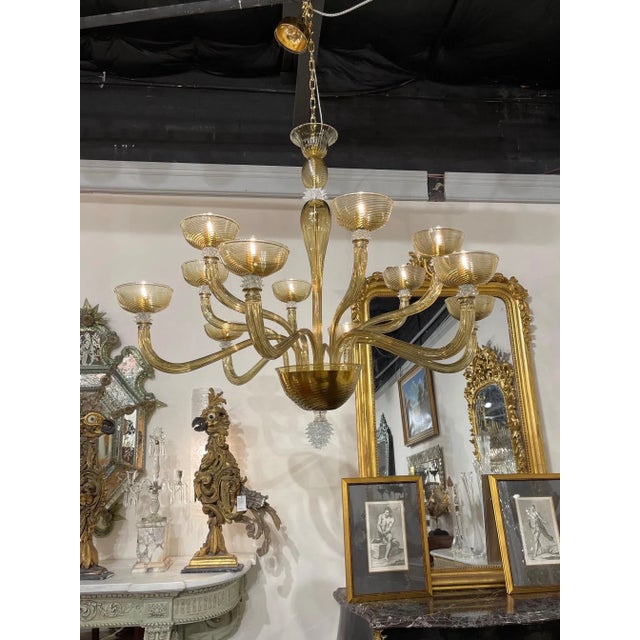 Spectacular modern gold Murano glass chandelier with 12 arms. This sparkling beauty makes a very impressive impact. A true...