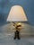 Vintage Hollywood Regency (1970s) table lamp. Beautifully preserved linen, conical shade with gold-colored trim. Heavy...