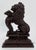 Large vintage cast iron doorstop featuring regal lion figure on podium. Very heavy with a great presence. Age wear.