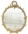 Great antique Hollywood Regency style wall mirror from the early 1900's. The large oval mirror is made of wood with...