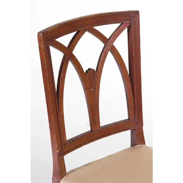 A sophisticated pair of Italian Neoclassical side chairs made early in the 19th century. The square tapered legs are...