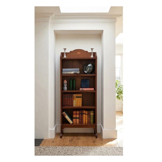 K0650 english edwardian mahogany bookcase of slim and narrow proportion, having a shaped and fan inlaid in upstand above...