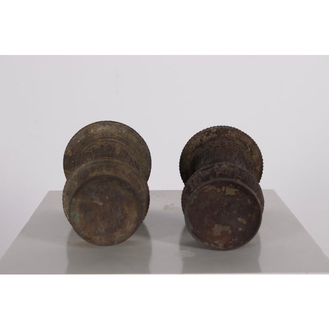 A pair of traditional bronze ghee (butter) lamps, Nepal, 19th century. One of the lamps has a duller patina (see photo)....