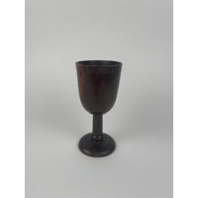 This treen cup, dating to the 18th or 19th century, is a fine example of traditional wooden domestic wares crafted with...