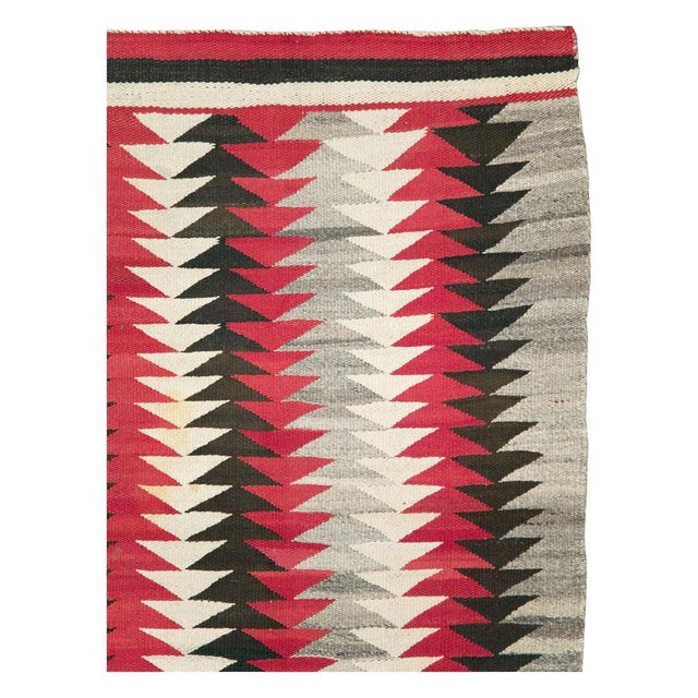 A vintage American flatweave throw rug handmade by the Navajo tribe during the mid-20th century. Measures: 3' 1" x 4' 9".