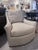 Comfortable upholstered swivel chair with a traditional skirted base.