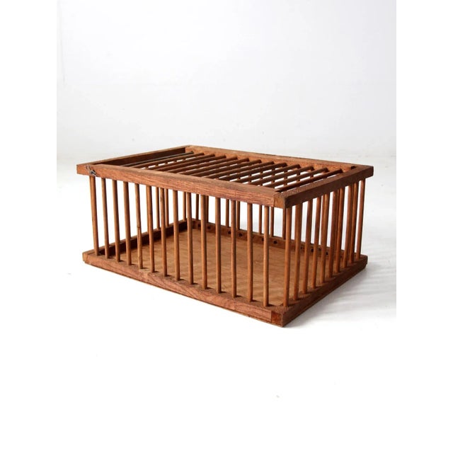 This is a vintage wooden farm crates circa mid 20th century. The wood crate features a hinged lid with bar and clip...