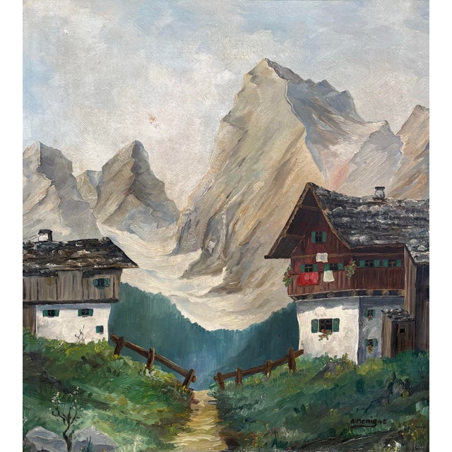 A European oil painting of a pair of chalets in the Alps. Signed A. Menig and dated 1945. Painted on the back of an old...