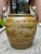 Antique ceramic pot featuring an intricately carved or embossed dragon motif. The pot has a rich, earthy glaze in shades...