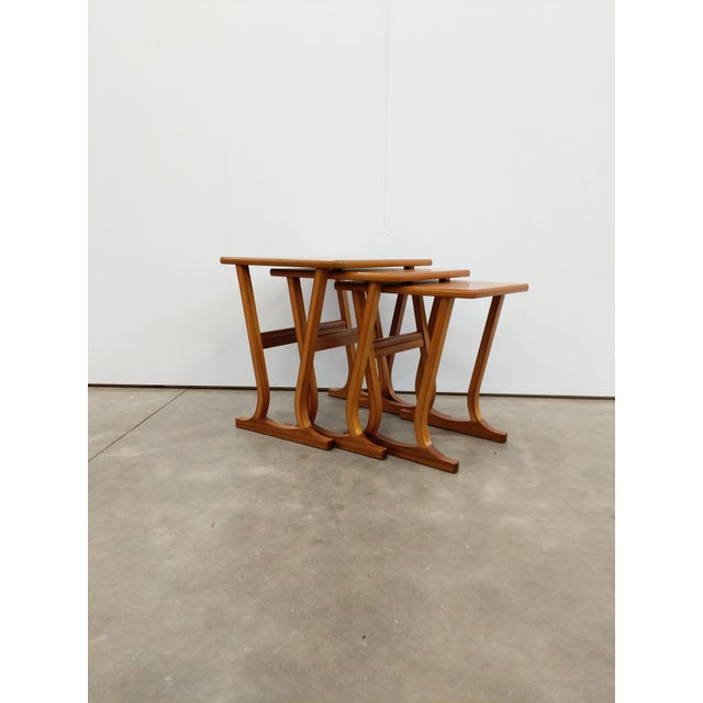 Set of 3 authentic vintage mid century modern teak nesting tables. By Parker Knoll. Maker's label on bottom. This set is...