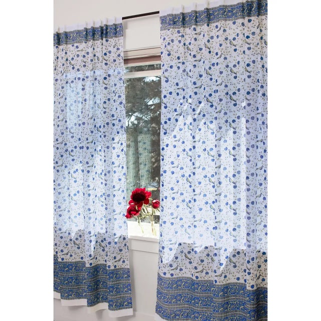 The celebrated Birds on Vine design displays a whimsical pattern of birds perched on flowering vines, set against a...