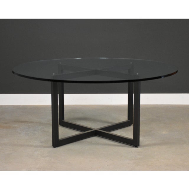 A mid century round dining table or patio table with a glass top. Glass has some scratches but no chips. One dimple shown....