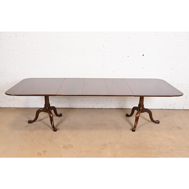 An exceptional Georgian or Regency style solid cherry wood double pedestal extension dining table By Henkel Harris USA,...