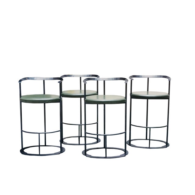 Four Catilina stools with painted steel frame, plywood seat and polyurethane cushions padded and upholstered in green...
