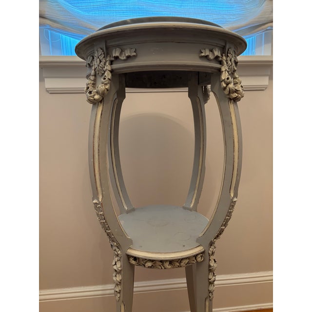 Beautiful French pedestal with floral motif on the legs and floral swags on the top section, two tiers with marble on top....